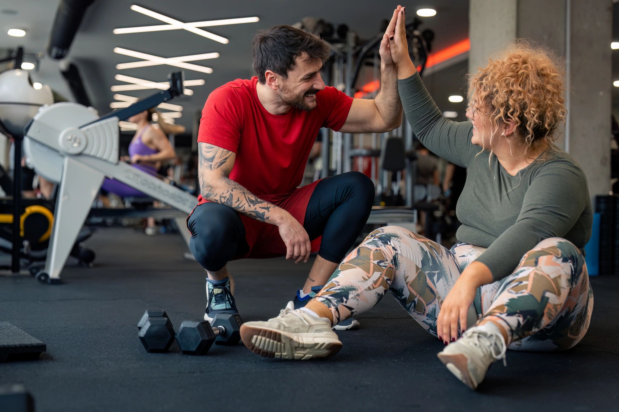 Coach and client celebrating with a high-five after training