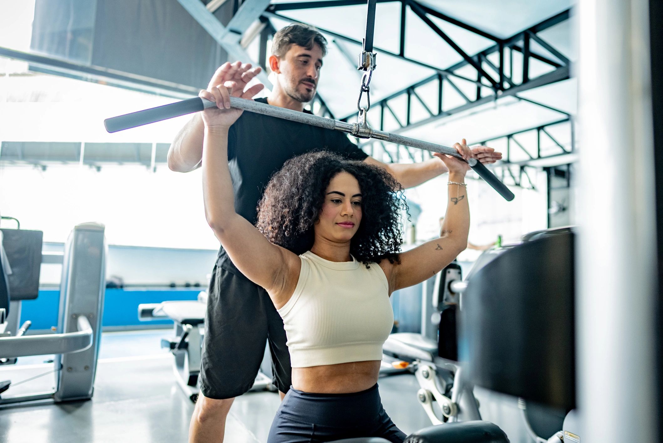 Trainer coaching a client during a strength workout at the gym